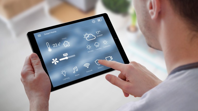 A man holding a tablet with Smart Home controls