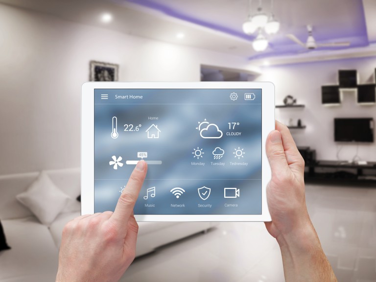 Two hands holding a tablet that controls Smart Home features