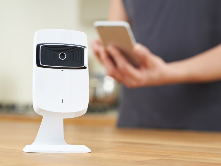 Smart camera, a person in the background is holding a smartphone